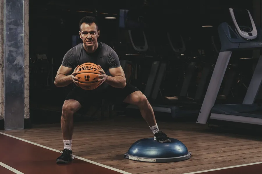 Balance work on a BOSU with a Basket Bullet medicine ball