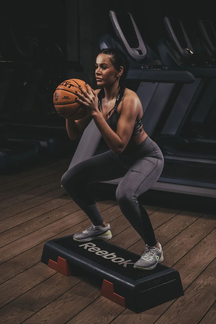 Step squats with a Basket Bullet medicine ball